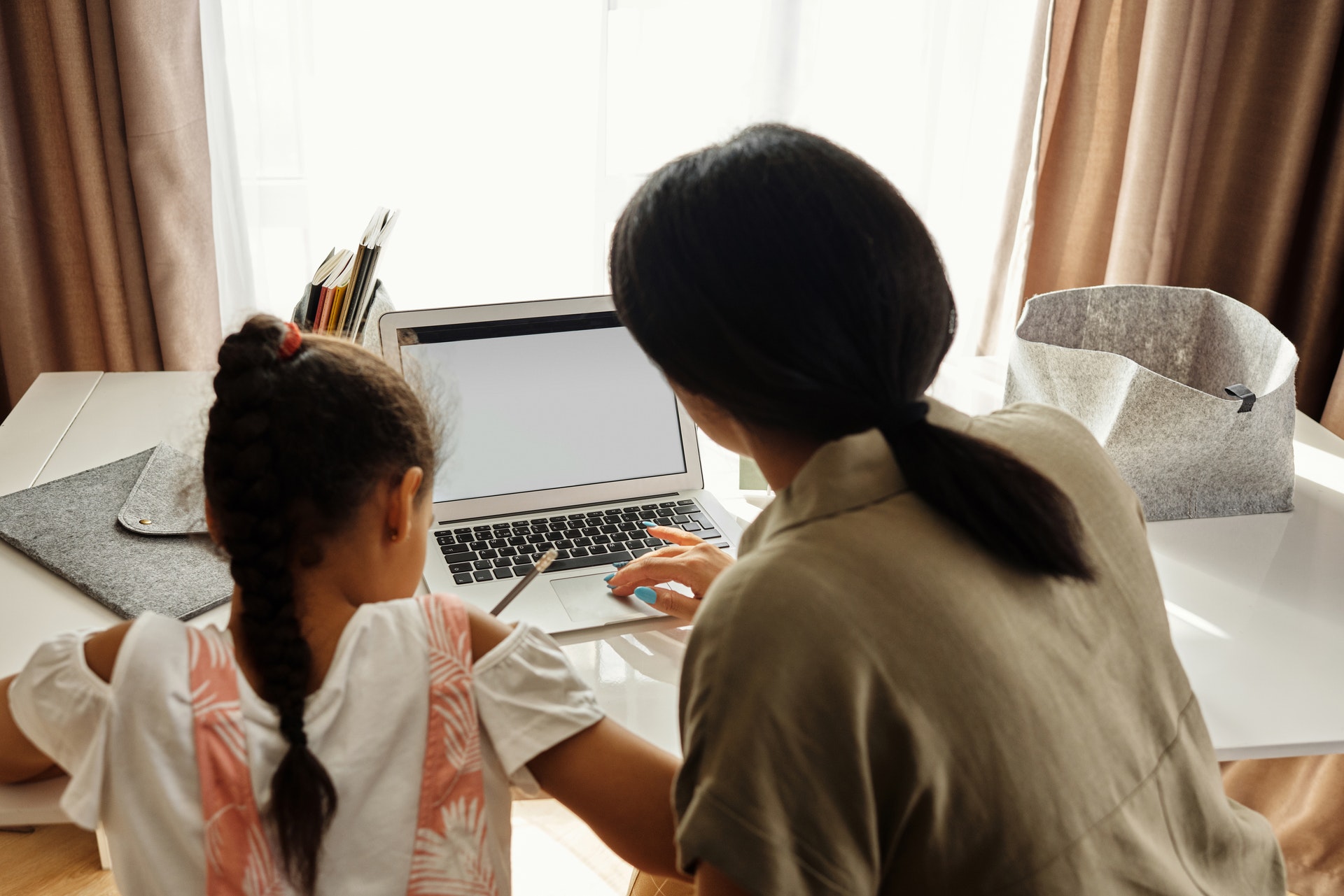mother-helping-her-daughter-with-homework-4260475