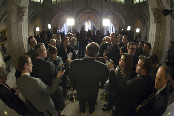 New Democratic Party leader Tom Mulcair speaks with journalists in the House of Commons foyer on Feb. 4, 2014. The Hill Times photograph by Jake Wright