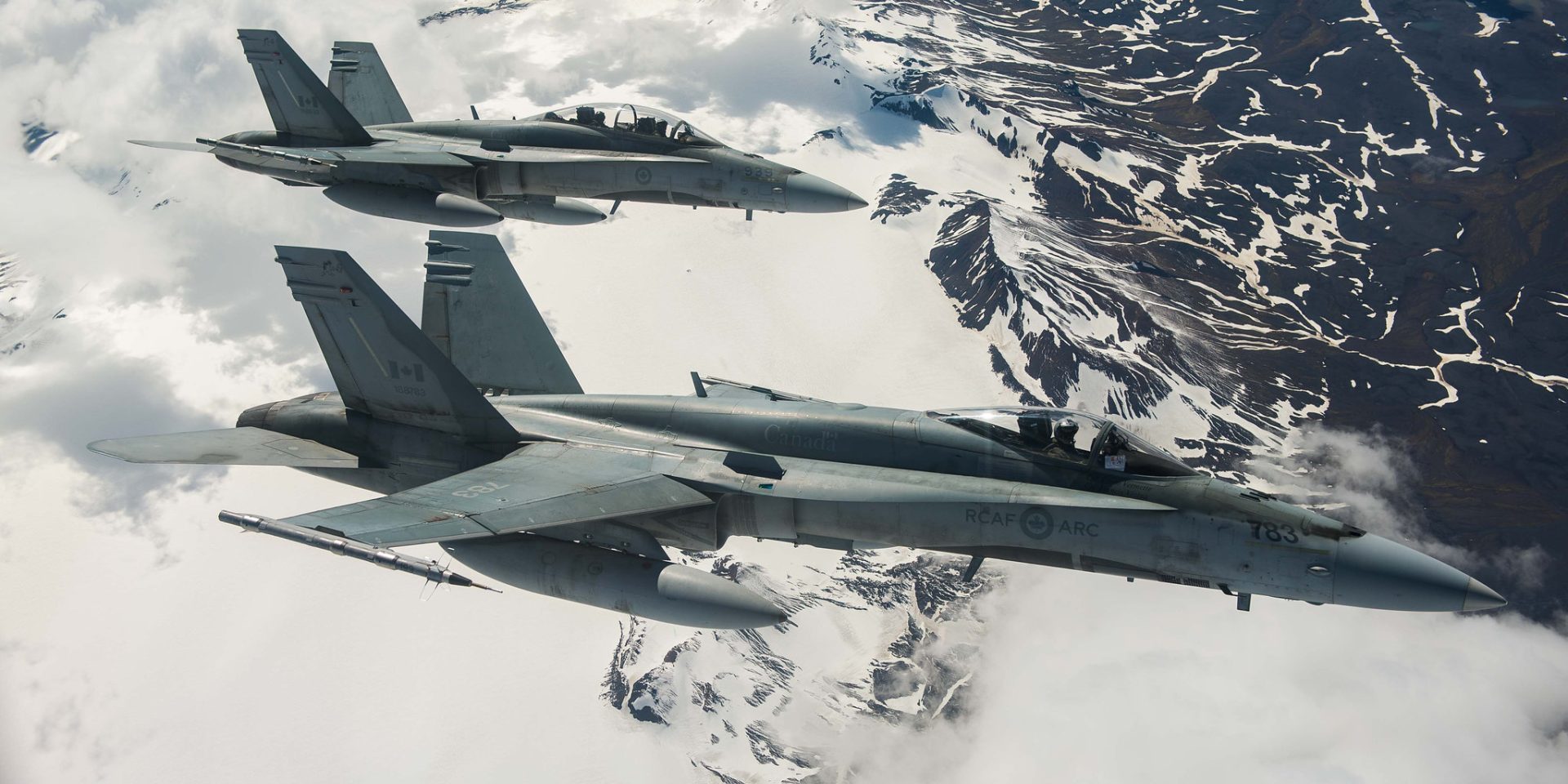 Royal Canadian Air Force CF-188 Hornet fighters fly over Iceland on May 31, 2017, during an Operation Reassurance surveillance mission. DND photograph by Corporal Gary Calvé