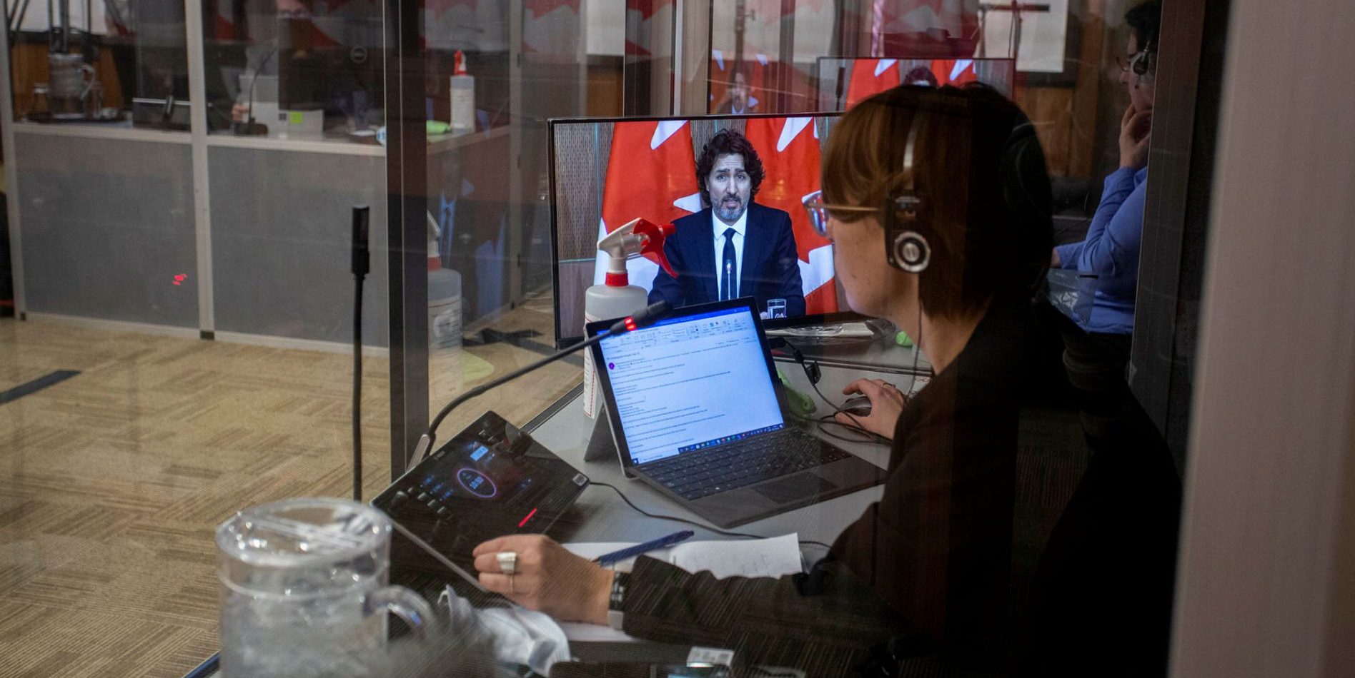 Interpreters are pictured at work in sound booths during a press conference with Prime Minister Justin Trudeau in the Sir John A. Macdonald Building in February 2021.  Andrew Meade