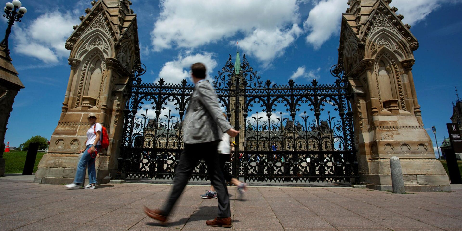 Pedestrians walk past the gates to Parliament Hill on July 13, 2022. Andrew Meade