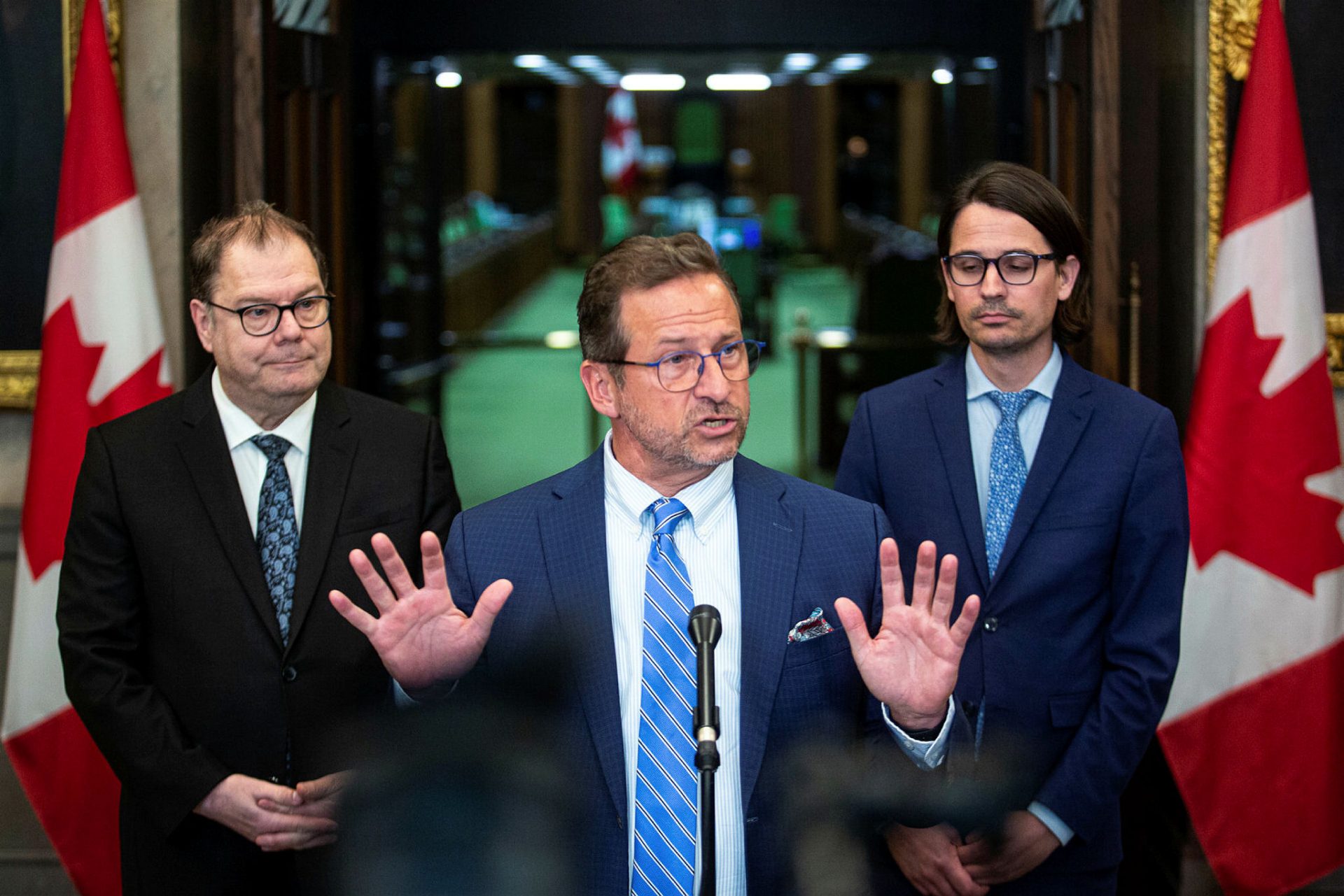 Bloc Québécois leader Yves-Francois Blanchet speaks with reporters before Question Period on  May 17, 2023, flanked by his party's language critic and MP for La Pointe-de-l'Île Mario Beaulieu and the MP for Mirabel Jean-Denis Garon.