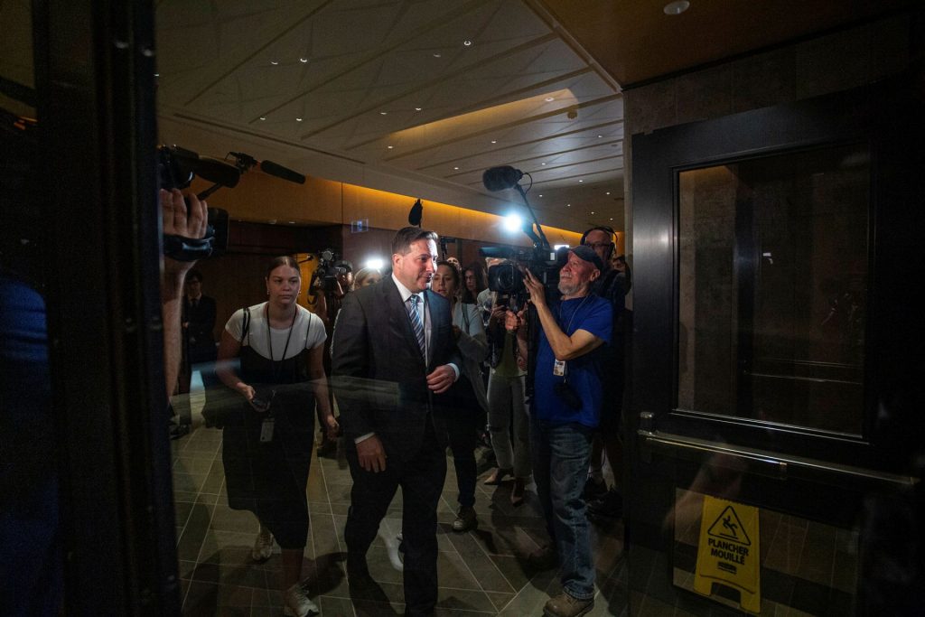 Marco Mendicino walks away from a scrum of reporters after facing questions about his office's knowledge of the transfer of notorious prisoner Paul Bernardo to a lower security prison.