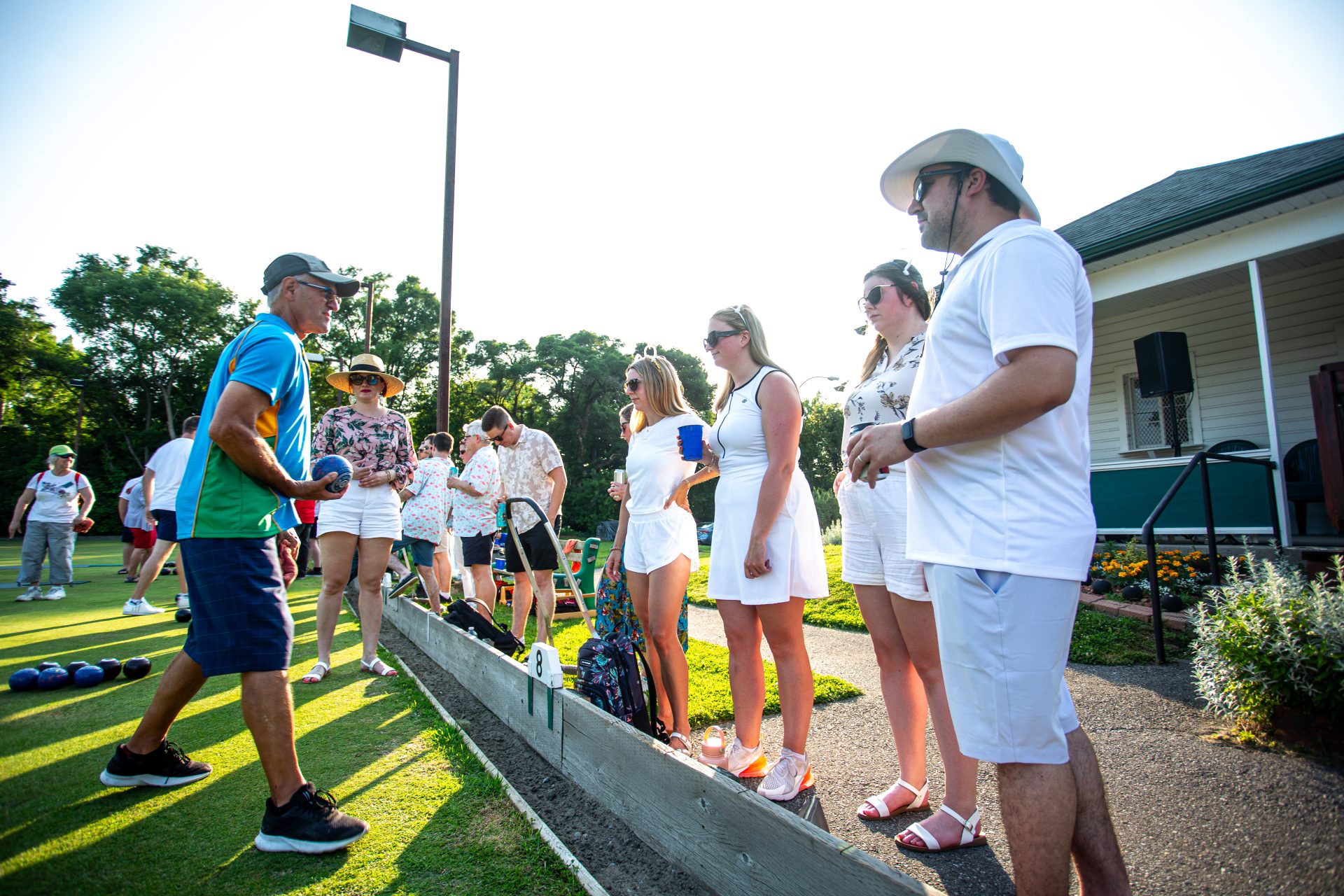 Elmdale Lawn Bowling Club member Ken Waterman, left, provides some pre-match pointers to The Bowler Bears, Eric Gollinger, Alexis Small, Katie Vaughan, and Catherine MacDonald at Lawn Summer Nights, a fundraiser for Cystic Fibrosis Canada at the Elmdale Lawn Bowling Club in Ottawa on July 5, 2023.