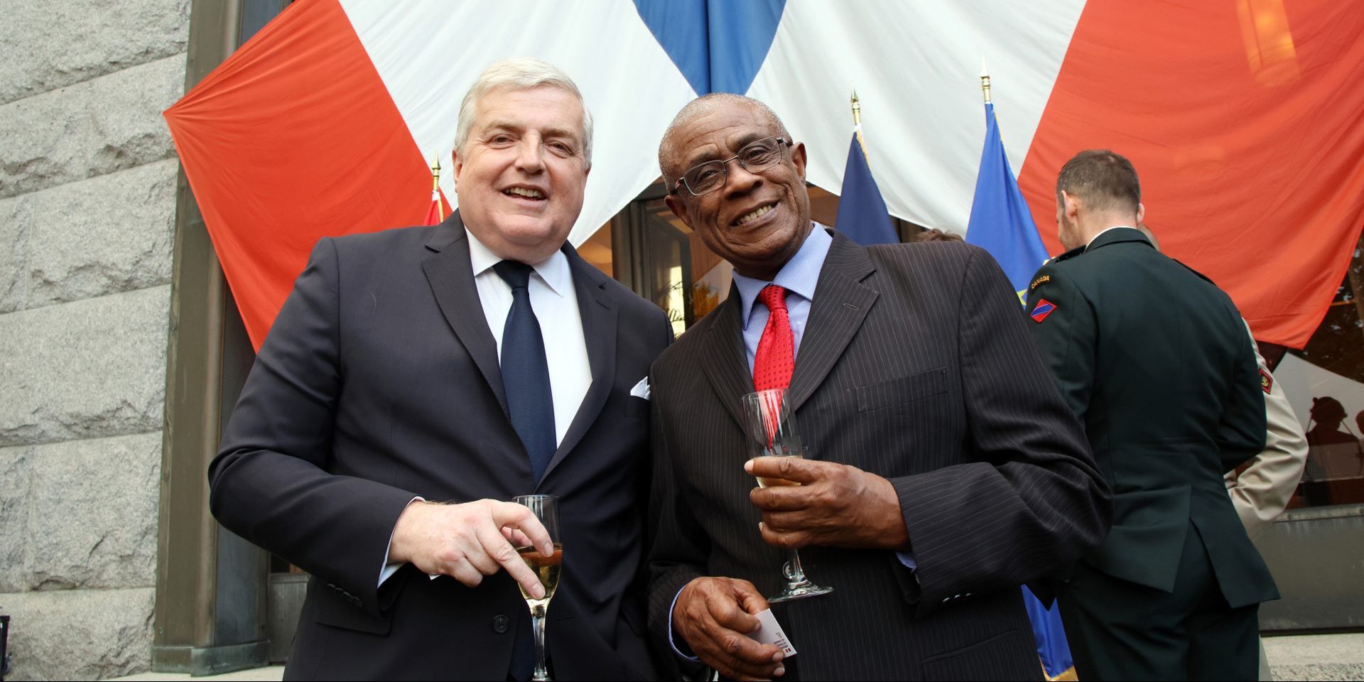 French Ambassador Michel Miraillet, left, and High Commissioner of Barbados Gline Clarke enjoy a glass of champagne at the Bastille Day garden party on July 14 at the French Embassy in Ottawa.