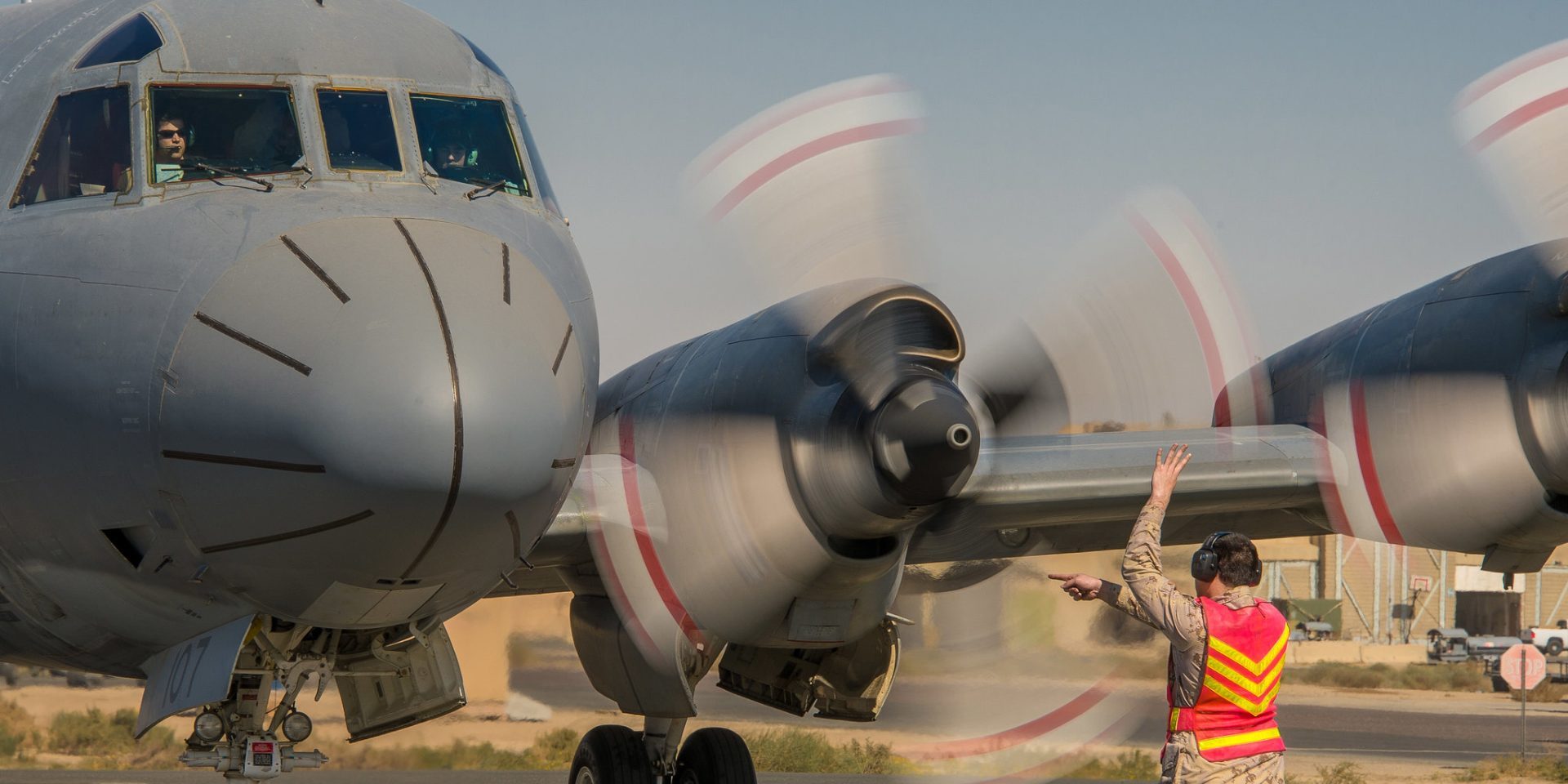 A Royal Canadian Air Force technician guides a CP-140 Aurora to its parking space during Operation IMPACT in Kuwait on February 5, 2015.

 

Photo: Canadian Forces Combat Camera, DND