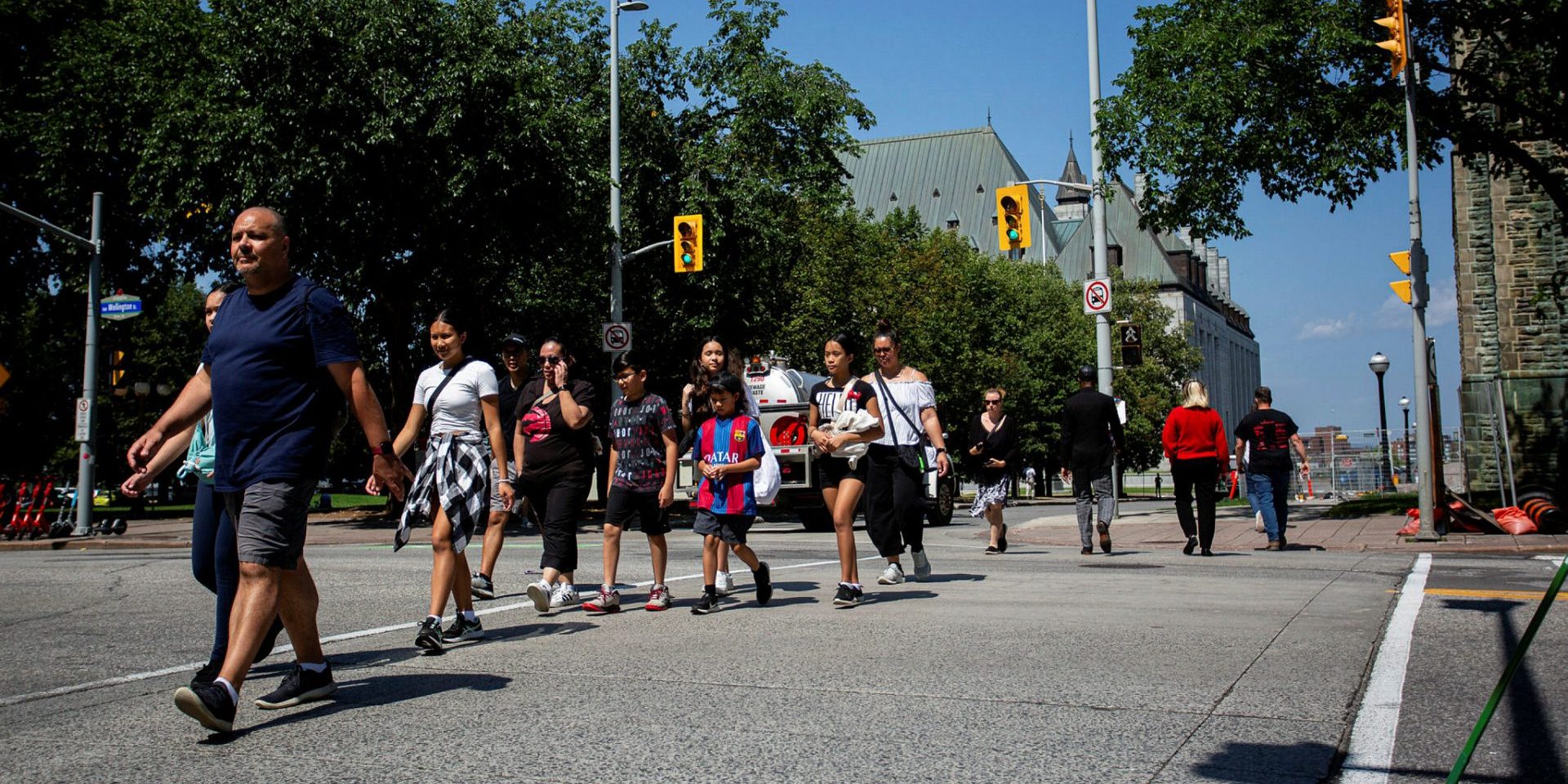 Pedestrians cross Wellington Street near the Supreme Court of Canada on Aug. 9, 2023. Andrew Meade