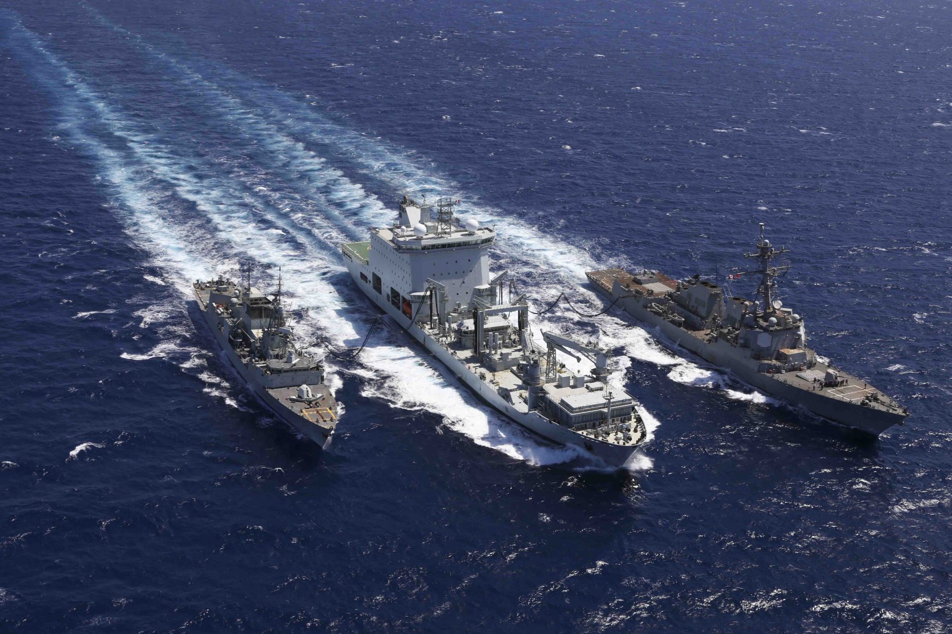 Combat Support Ship Asterix (centre) resupplies US destroyer USS Truxtun and Canadian frigate HMCS Montreal during evacuation efforts offshore Sudan during May 2023. (US Department of Defense)