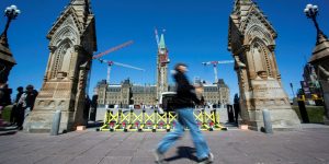 A person walks past the Queen’s Gate on April 23, 2025. The Hill Times photograph by Andrew Meade