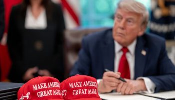 President Donald Trump signs executive orders alongside Secretary of Education Linda McMahon and wounded warriors in the Oval Office, Wednesday, April 23, 2025. (Official White House Photo by Molly Riley via Flickr)