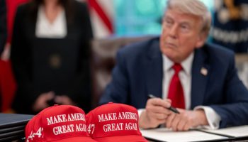 President Donald Trump signs executive orders alongside Secretary of Education Linda McMahon and wounded warriors in the Oval Office, Wednesday, April 23, 2025. (Official White House Photo by Molly Riley via Flickr)