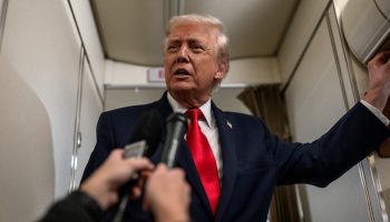 President Donald Trump answers questions from members of the media aboard Air Force One en route to Mount Pocono, Pennsylvania, for a rally on the economy, Tuesday, December 9, 2025. White House photograph by Molly Riley