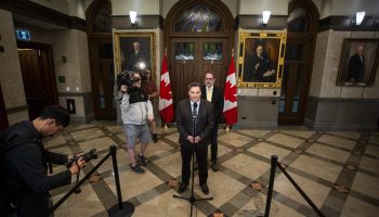 NDP interim leader Don Davies, centre, and NDP House Leader Alexandre Boulerice holds a press conference in West Block on  June 20, 2025. The Hill Times Photograph by Andrew Meade