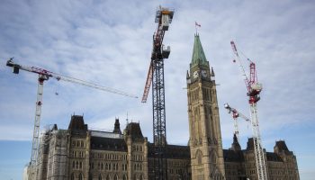 Two newly erected tower cranes in the front of Centre Block are pictured on Jan. 22, 2025.  The Hill Times photograph by Andrew Meade