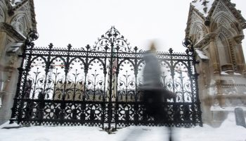 People walk past the Queen’s Gate on Parliament Hill  on Jan. 7, 2026. The Hill Times photograph by Andrew Meade