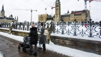 A person walks along Wellington Street past Centre Block on Jan. 13, 2026. The Hill Times photograph by Andrew Meade