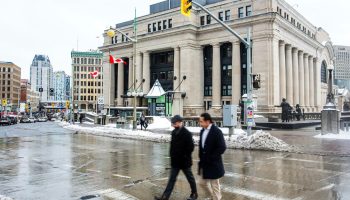 A person walks along Wellington Street past the Senate of Canada Building on Jan. 13, 2026. The Hill Times photograph by Andrew Meade