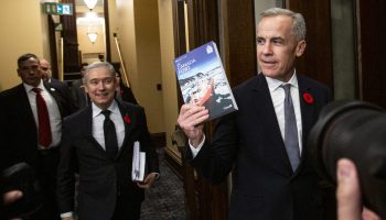 Prime Minister Mark Carney and Minister of Finance and National Revenue François-Philippe Champagne take the 2025 budget into the House of Commons to table iton  Nov. 4, 2025. The Hill Times photograph by Andrew Meade