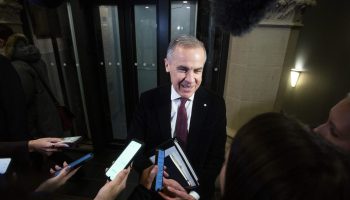 Prime Minister Mark Carney speaks with reporters before the Liberal party caucus meeting in West Block  on Dec. 10, 2025. The Hill Times photograph by Andrew Meade