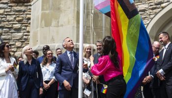 Prime Minister Mark Carney and Minister of Women and Gender Equality and Secretary of State Small Business and Tourism Rechie Valdez raises the Pride flag on Parliament Hill on June 10, 2025. The Hill Times photograph by Andrew Meade