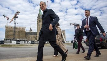 Prime Minister Mark Carney walks across Parliament Hill on his way to West Block on March 10, 2026. The Hill Times photograph by Andrew Meade