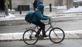 A cyclist rides their bike along Wellington Street on Feb. 18, 2021. Andre Meade