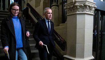 Newly elected party leader Mark Carney arrives for the Liberal Party caucus meeting in West Block on March 10, 2025. The Hill Times photograph by Andrew Meade