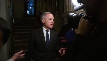 Prime Minister Mark Carney speaks with reporters before the Liberal party caucus meeting in West Block  on Feb. 25, 2026. The Hill Times photograph by Andrew Meade