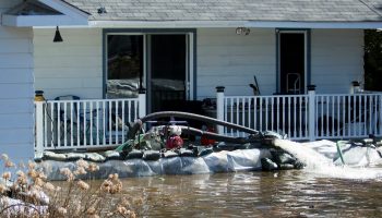 Water is pumped from a flooded home in Constance bay on Apr. 30, 2019.