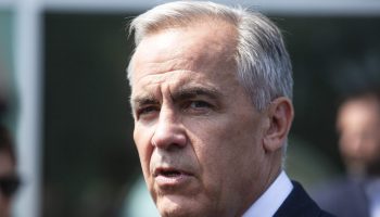 Prime Minister Mark Carney scrums with reporters as he leaves the Metis Major Projects Summit in Ottawa on Aug. 7,  2025. The Hill Times photograph by Andrew Meade
