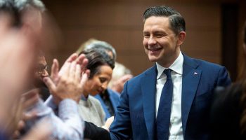 Conservative Party Leader Pierre Poilievre shakes hands with caucus members after speaking before his caucus meeting in West Block on Sept. 14,  2025. The Hill Times photograph by Andrew Meade