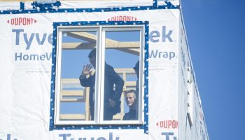 Minister of Housing and Infrastructure and Minister responsible for Pacific Economic Development Canada Gregor Robertson gives a wave as he tours a Caivan modular home construction site in Napean, Ont. on Sept. 14,  2025, before he makes an announcement about  Build Canada Homes and the government plans to expand and innovate home building. The Hill Times photograph by Andrew Meade