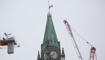 The Canadian flag flies at half mast on Parliament Hill on Feb. 11, 2026, in response to the school shooting at Tumbler Ridge Secondary School in British Columbia. The Hill Times photograph by Andrew Meade