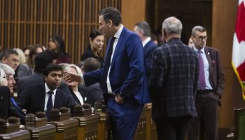 Minister of Artificial Intelligence and Digital Innovation and Minister responsible for the Federal Economic Development Agency for Southern Ontario Evan Solomon speaks with colleagues in the House of Commons before proceedings on  Feb. 11, 2026. The Hill Times photograph by Andrew Meade
