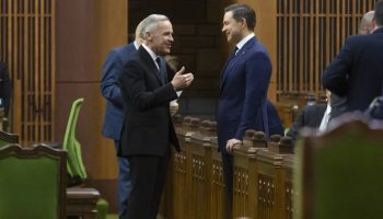 Prime Minister Mark Carney and Conservative Leader Pierre Poilievre share a friendly moment before they each addressed the House of Commons on Feb. 11 about the Tumbler Ridge tragedy. The Hill Times photograph by Andrew Meade