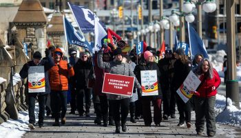 Members of Public Service Alliance of Canada locals hold a demonstration outside the Prime Minister’s Office on Feb. 24, 2023. The Hill Times photograph by Andrew Meade