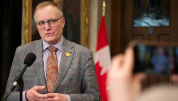 NDP MP Peter Julian speaks with reporters in the House of Commons foyer before Question Period on  Feb. 15, 2024.