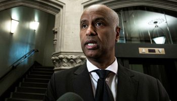 Minister of International Development Ahmed Hussen speaks with reporters as he arrives for the Liberal party caucus meeting in West Block  on Feb. 28, 2024.