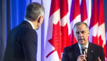 Prime Minister Mark Carney and Mayor of Ottawa Mark Sutcliffe have a conversation on stage at the Ottawa Mayor’s Breakfast at the Rogers Centre on Dec. 8, 2025. The Hill Times photograph by Andrew Meade
