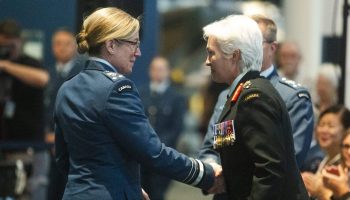 Lieutenant-General Jamie Speiser-Blanchet shakes hands with Chief of Defence Staff General Jennie Carignan after assuming command of the Royal Canadian Air Force at the Canada Aviation and Space Museum on  July 10, 2025. The Hill Times photograph by Andrew Meade