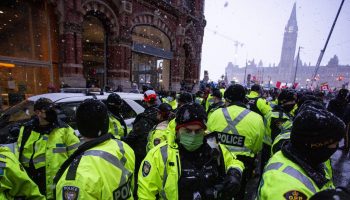 Ontario Provincial Police arrest a man, in the orange hat, on Metcalfe Street on Feb. 17, 2022 as the Freedom convoy’s occupation of downtown Ottawa enters the third week.