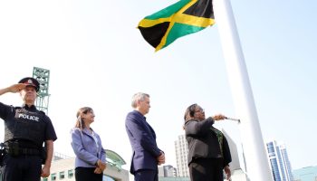 Jamaican High Commissioner Marsha Coore Lobban flies her country's flag in the sky as Ottawa Mayor Mark Sutcliffe and Global Affairs Canada's Sylvie Bédard watch. The Hill Times photograph by Sam Garcia