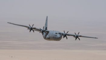"A Royal Canadian Air Force CC-130J Hercules aircraft deployed on Operation IMPACT flies over the Kuwait desert on June 13, 2020.  Photo: Cpl Nicolas Alonso, Canadian Armed Forces photo ~ Un avion CC-130J Hercules de l'Aviation royale canadienne déployé dans le cadre de l'opération IMPACT survole le désert du Koweà¯t le 13 juin 2020.  Photo : Cpl Nicolas Alonso, Forces armées canadiennes"