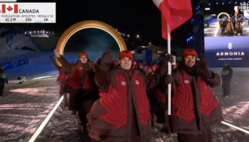 Team Canada flagbearers Mikaël Kingsbury, left, and Marielle Thompson enter the Milano Cortina Games on Feb. 6.  Screenshot courtesy of CBC