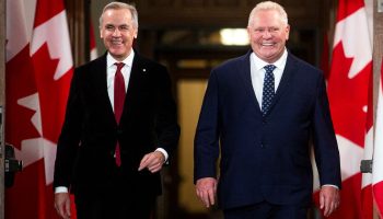 Prime Minister Mark Carney and Ontario Premier Doug Ford arrive for a signing ceremony in West Block on Dec. 18, 2025, where the federal and Ontario governments sign a cooperation agreement to work together on development projects . The Hill Times photograph by Andrew Meade