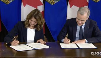 Alberta Premier Danielle Smith, left, and Prime Minister Mark Carney signed their new energy framework in Calgary on Nov. 27. Screenshot courtesy of CPAC